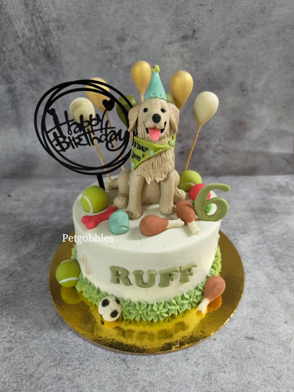 A Pet Gobbles celebration cake topped with a figurine